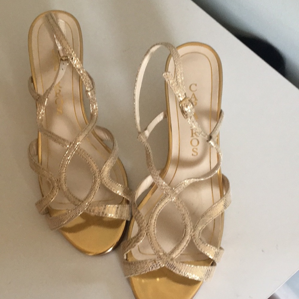 Elegant gold sandals .